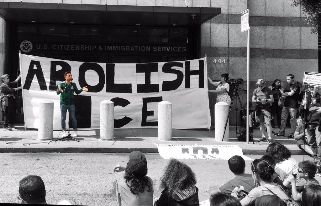 Edwin Carmona-Cruz speaks outside ICE Headquarters at a protest in San Francisco