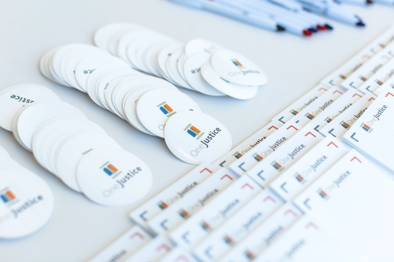 a group of white round badges and post its